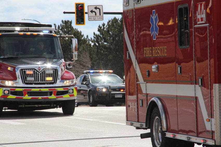 Fire rescue and police vehicles pass March 8 on Lucent Boulevard in Highlands Ranch in a procession to a memorial service for firefighter Cody Mooney.